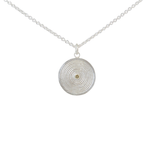 Sterling silver pendant necklace with a circular design set with a yellow diamond