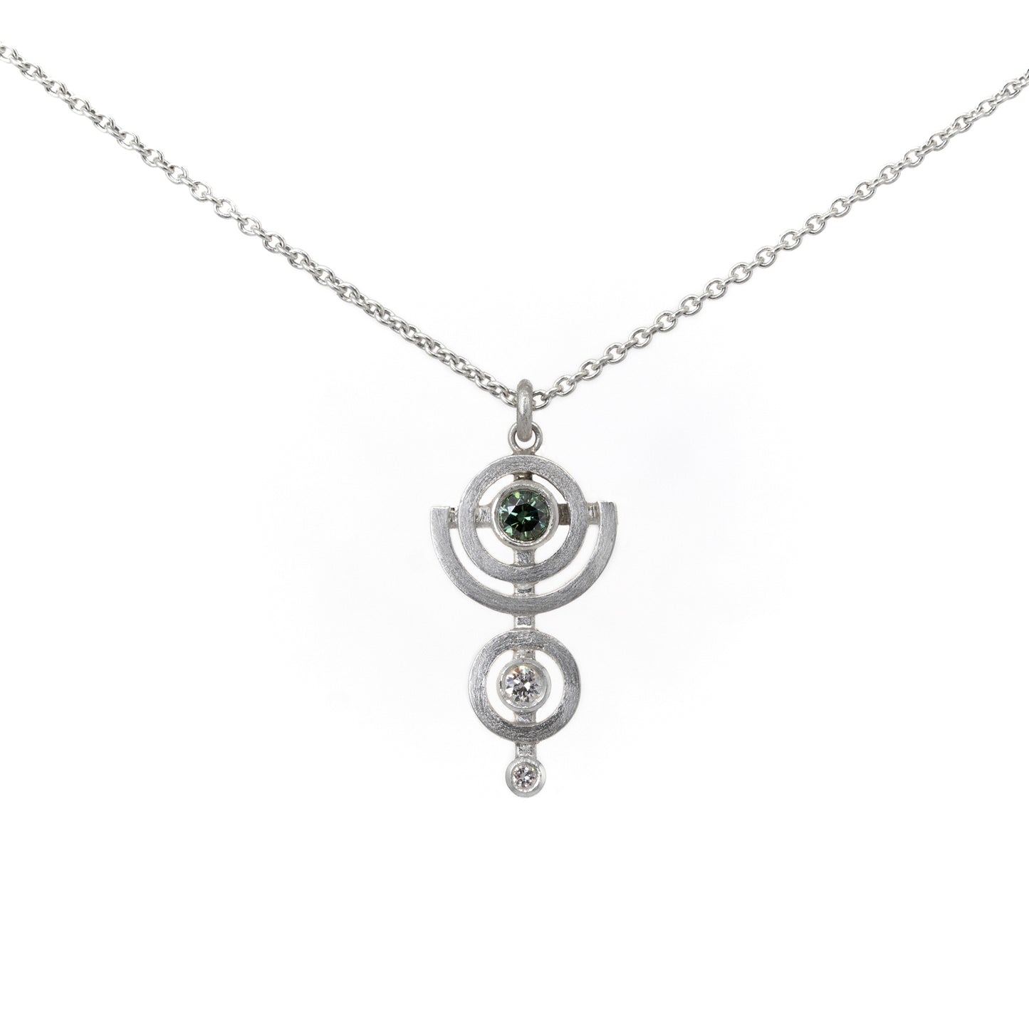 Silver necklace with a pendant featuring a green diamond on a white background