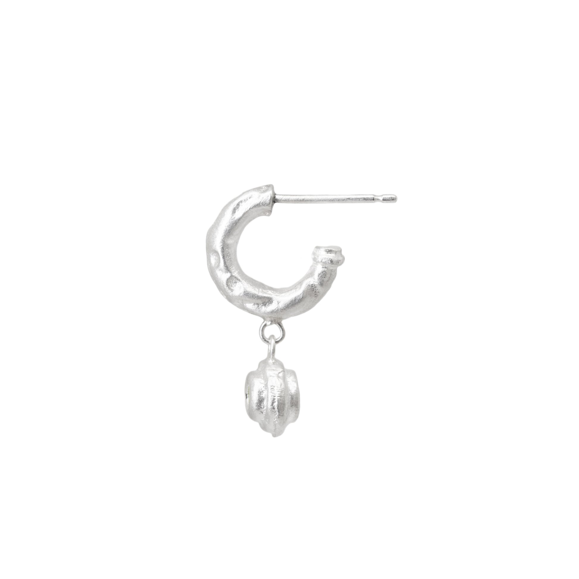 Silver hoop earring with a small round sapphire charm on a white background