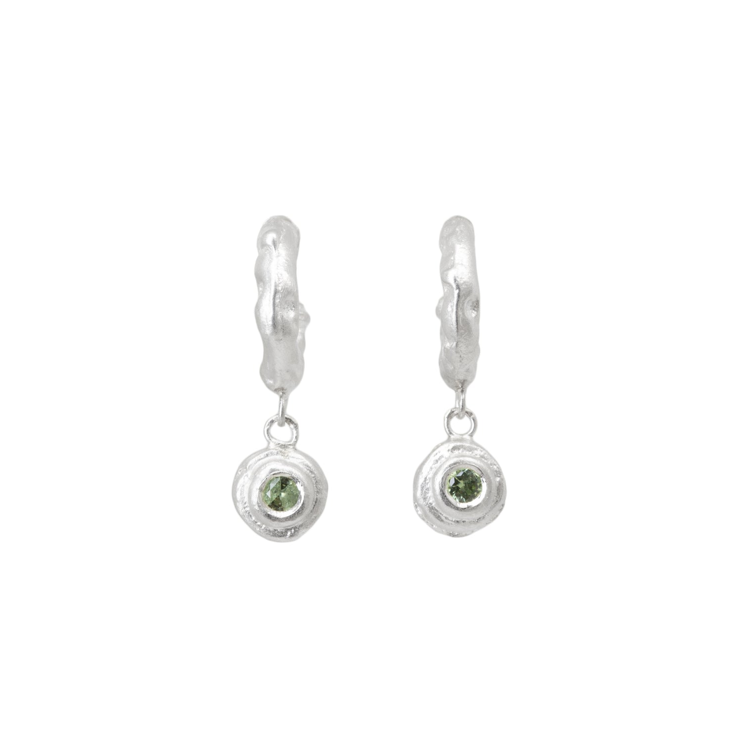 Pair of silver hoop earrings with green sapphires on a white background
