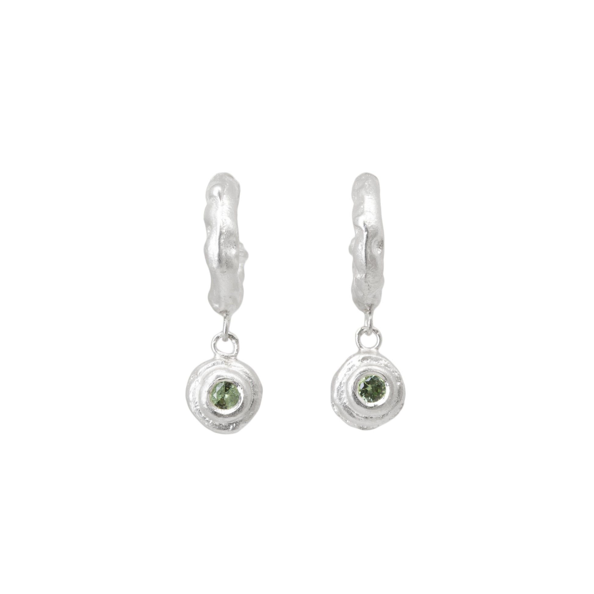 Pair of silver hoop earrings with green sapphires on a white background