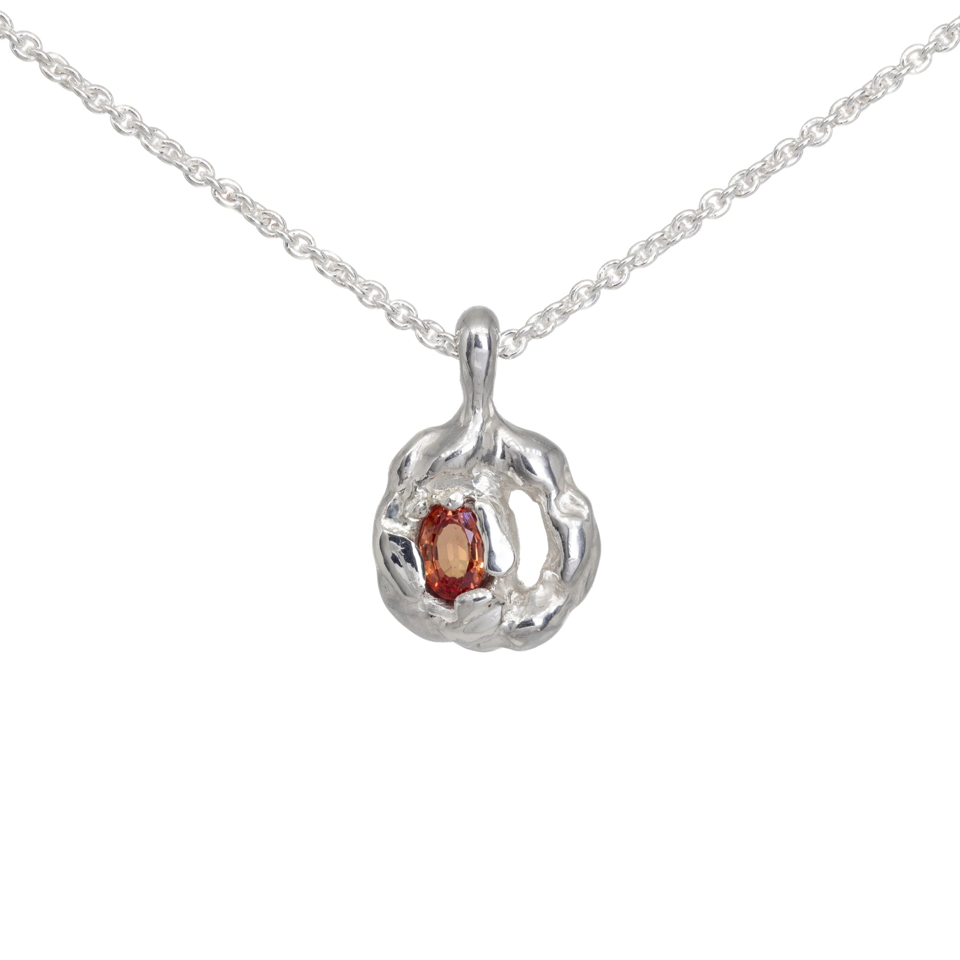 Silver pendant with molten texture set with orange sapphire