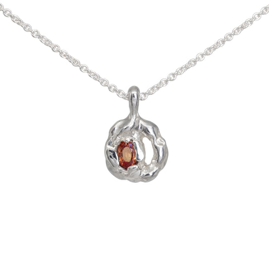 Silver pendant with molten texture set with orange sapphire