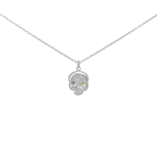 Sterling silver and yellow diamond skull pendant necklace on a white background