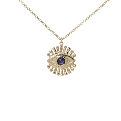 Gold necklace with an eye-shaped pendant set with a blue sapphire in place of the iris on a white background.