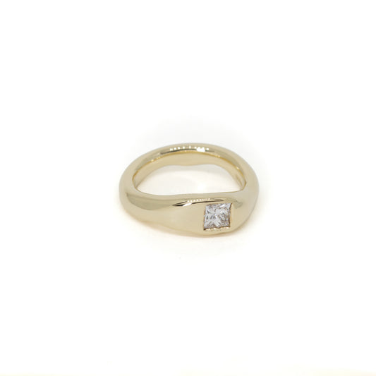 A yellow gold shaped wedding ring with a single princess-cut diamond flush set, shown on a plain white background.