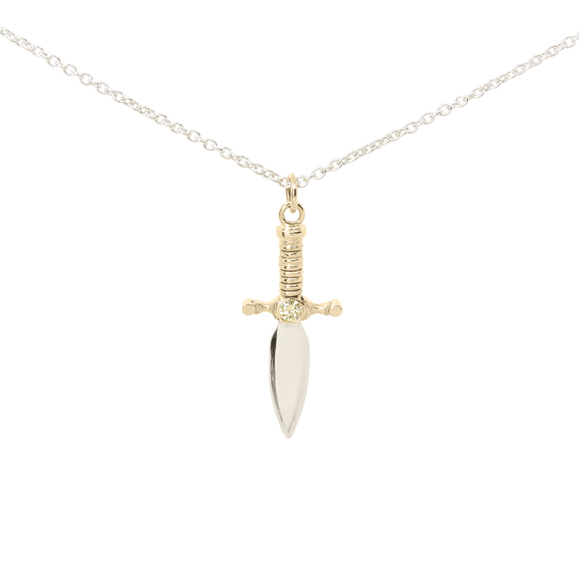 A dagger pendant necklace on a delicate silver chain, featuring a polished silver blade and a 9ct yellow gold hilt with yellow diamond set in the centre, set against a plain white background.