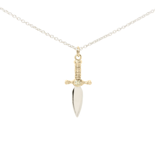 A dagger pendant necklace on a delicate silver chain, featuring a polished silver blade and a 9ct yellow gold hilt with yellow diamond set in the centre, set against a plain white background.