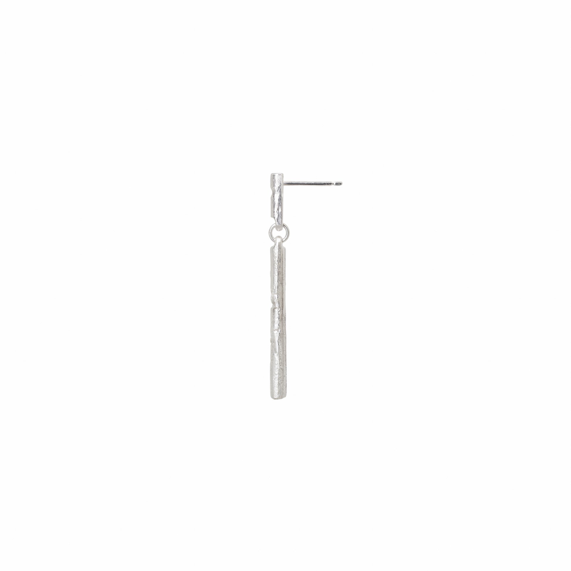 Side view of silver stud earring with diamonds on a white background