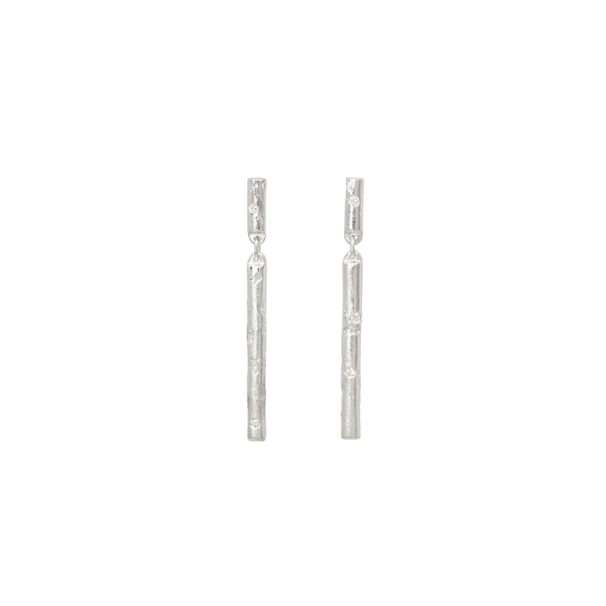 Pair of silver stud earrings with diamonds on a white background